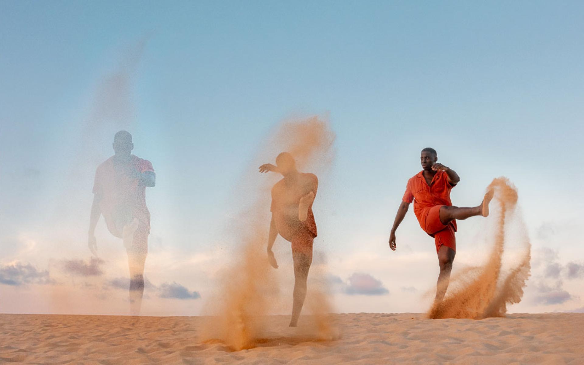 Man kicking sand